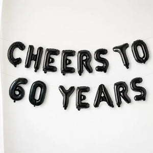 Black balloon letters spelling 'Cheers to 60 Years' on a white background