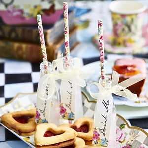 Whimsical Mad Hatter party bottles with “Drink Me” tags