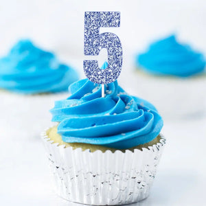 Blue glitter number 5 cake topper inserted on cake