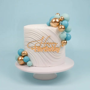blue cake ball toppers on modern cake