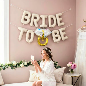Cream foil BRIDE TO BE balloon letters displayed for bridal shower