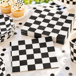 Black and white checkered paper napkins displayed on a racing car birthday party table