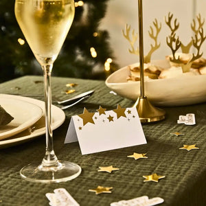 Folded Christmas star place cards with metallic gold star accents