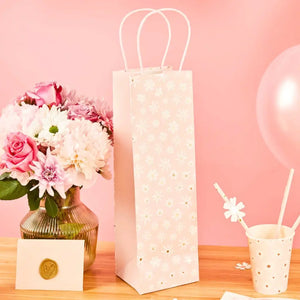 Light pink bottle gift bag with white daisy flowers and handles for wine gifts