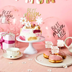 Mother's Day-themed setup with cake, donuts, and balloons