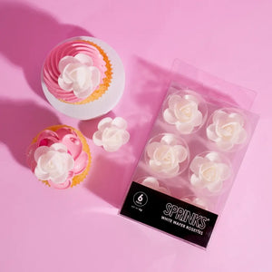 cupcakes decorated with white flower toppers