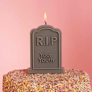 RIP Your Youth candle displayed on a birthday cake
