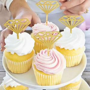 Cupcakes with diamond-shaped toppers on a white plate.