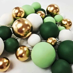 Mixed size foam ball cake decorations on stems