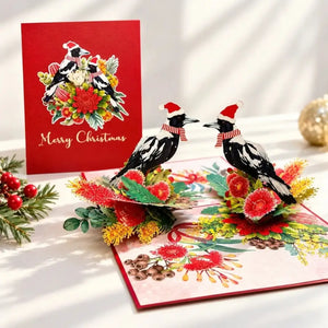 Magpie Christmas card decorated with Australian native flowers