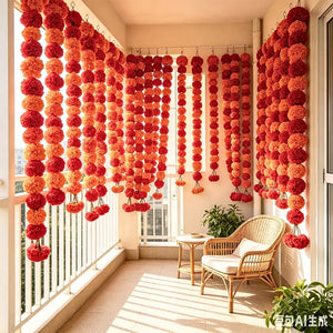 Traditional orange pom pom garland with bell hanging at a doorway for Diwali celebrations