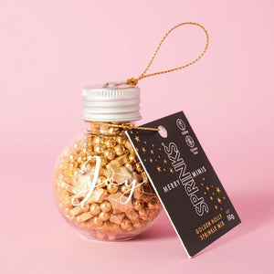 Glass JOY bauble filled with gold sprinkles and a hanging cord with gift tag