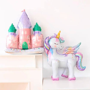 Colorful castle-shaped balloon and unicorn-shaped balloon on a white background
