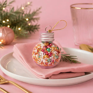 Sprinks Merry and Bright Christmas sprinkles inside a glass JOY bauble
