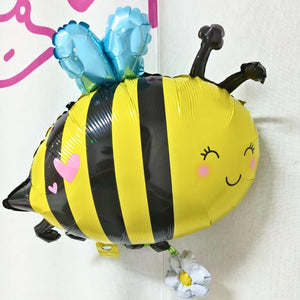 Bee-shaped balloon with a blue flower on a white background