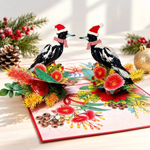 Two festive Australian magpies wearing Santa hats and striped scarves