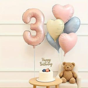 Heart-shaped foil balloons in pink, cream, and blue for birthday parties age 3