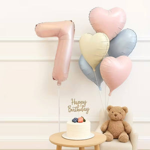 Jumbo pink number foil balloon with pink, cream, and blue heart foils number 7