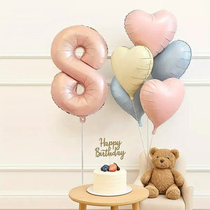 Heart-shaped foil balloons in pink, cream, and blue for birthday parties age 8