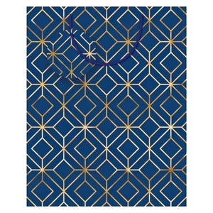 medium navy blue gift bag with gold geometric foil pattern, ribbon handles and matching gift tag
