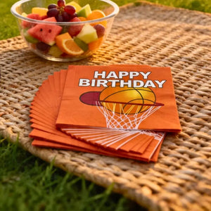Orange basketball party napkins with bold white birthday lettering