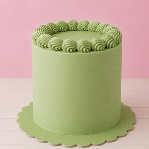 Pastel green round cake board with decorative scalloped edges