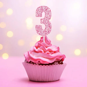 Pink glitter number 3 birthday numeral cake topper inserted on cake