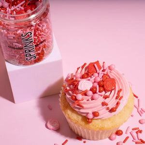 pink and red rose sprinkles mix close up on cupcake