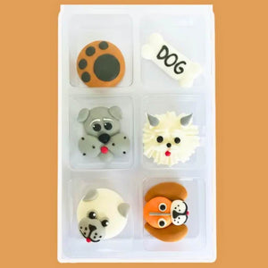 Close up of handmade royal icing dog faces and paw prints