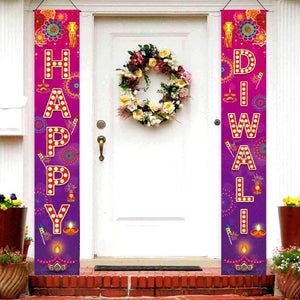 Decorative 'Happy Diwali' couplets on a door with a floral wreath.