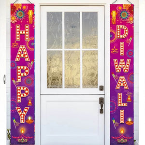 Decorative couplets with 'Happy Diwali' text hanging on a door.