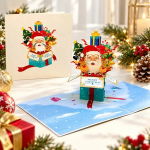 3D Christmas greeting card featuring Santa Claus and two reindeer inside a festive gift box