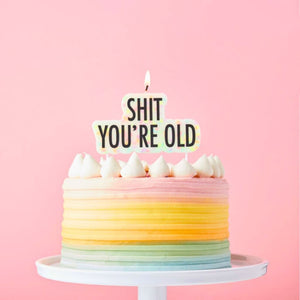 Sh*t You’re Old birthday candle cake topper in bold script on a pick
