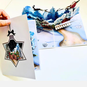 Snowy Village with Flying Santa on Sleigh & Reindeers Pop Card