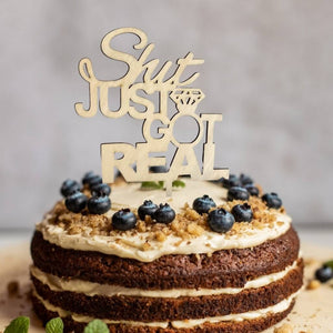 Wooden 'Shit Jut Got Real' Engagement Cake Topper