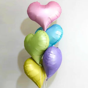 Colorful heart-shaped balloons on a white background