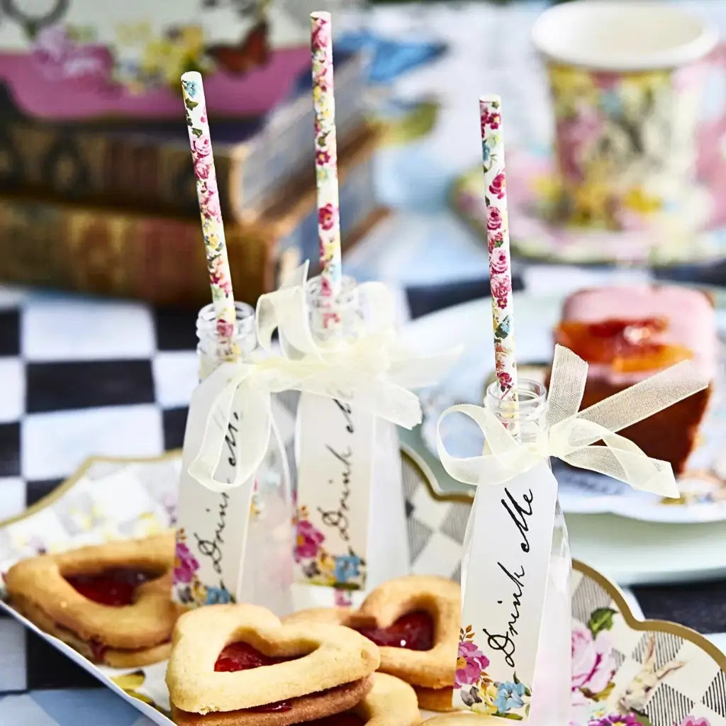 Whimsical Mad Hatter party bottles with “Drink Me” tags