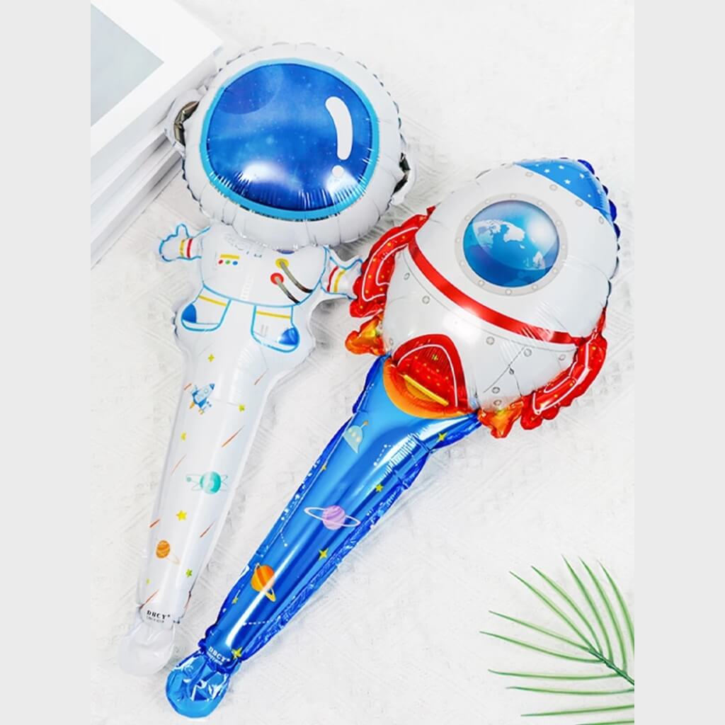 Two inflatable toys shaped like a rocket and an astronaut on a white background.