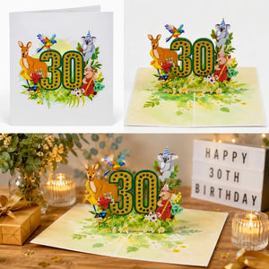 30th birthday card with pop-up design featuring animals and '30' on a wooden surface with candles and flowers.