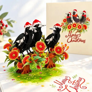 Three festive Australian magpies wearing Santa hats on a pop-up card
