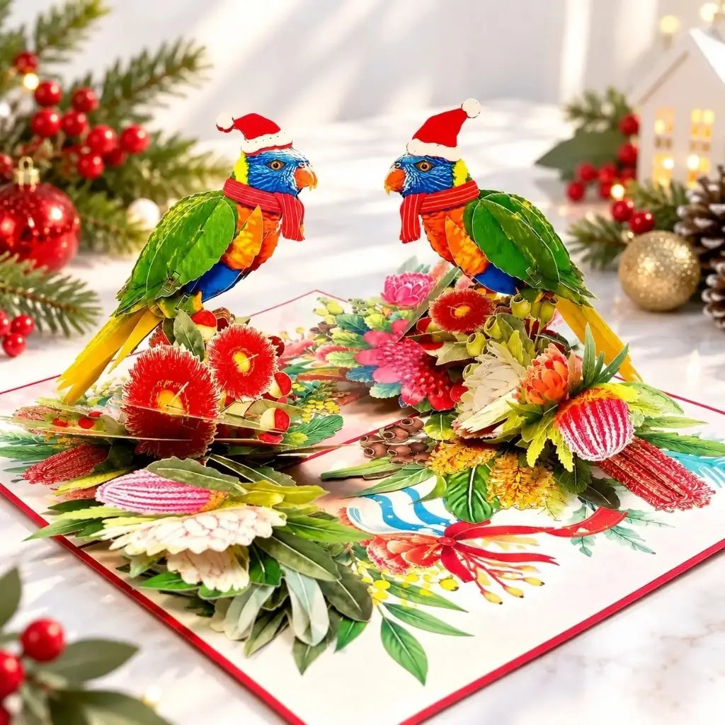 Two festive rainbow lorikeets wearing Santa hats and striped scarves