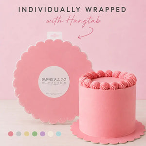 round pink cake board with an elegant scalloped border