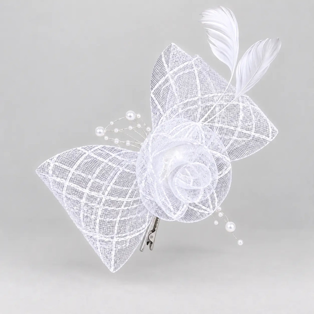 Bella white bridal flower fascinator hair clip worn with softly curled hair