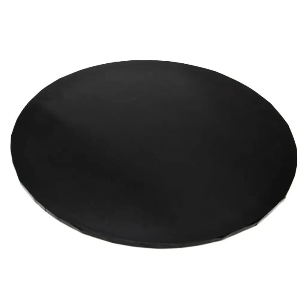 Close-up of the black masonite cake board showing its round shape and rigid edge