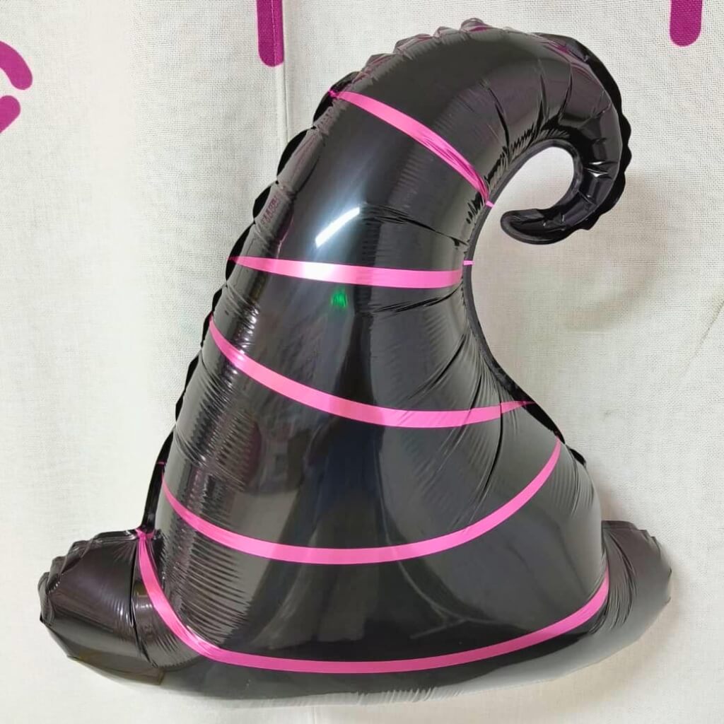 Black balloon with pink stripes on a white background