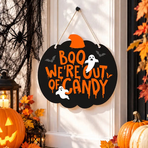 Black pumpkin Halloween sign reading Boo We’re Out of Candy
