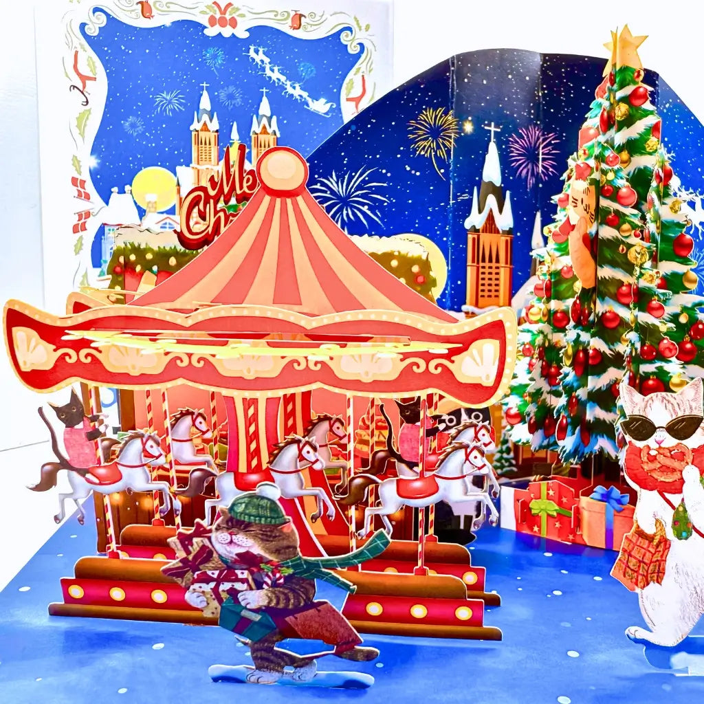 Whimsical 3D snowy village card with cats enjoying holiday fun