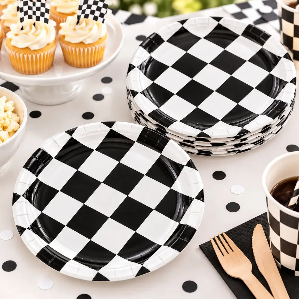 Black and white checkered paper plates arranged on a racing car birthday party table