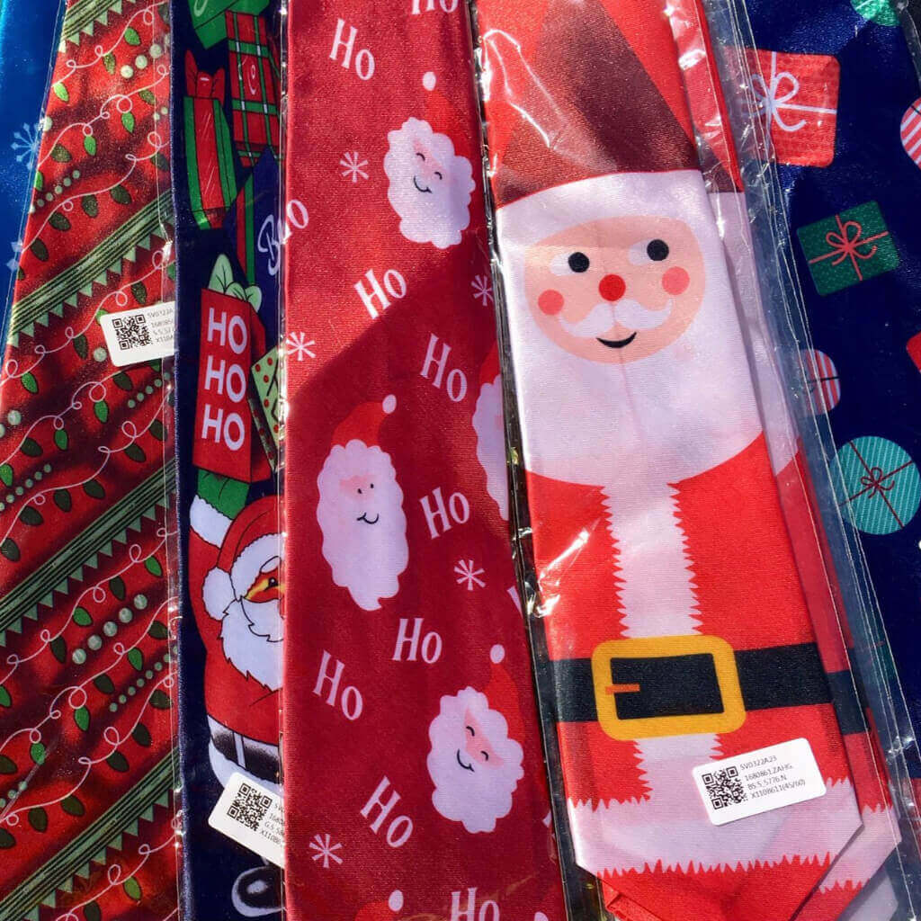 Collection of Christmas-themed fabric strips with Santa Claus and gift designs.
