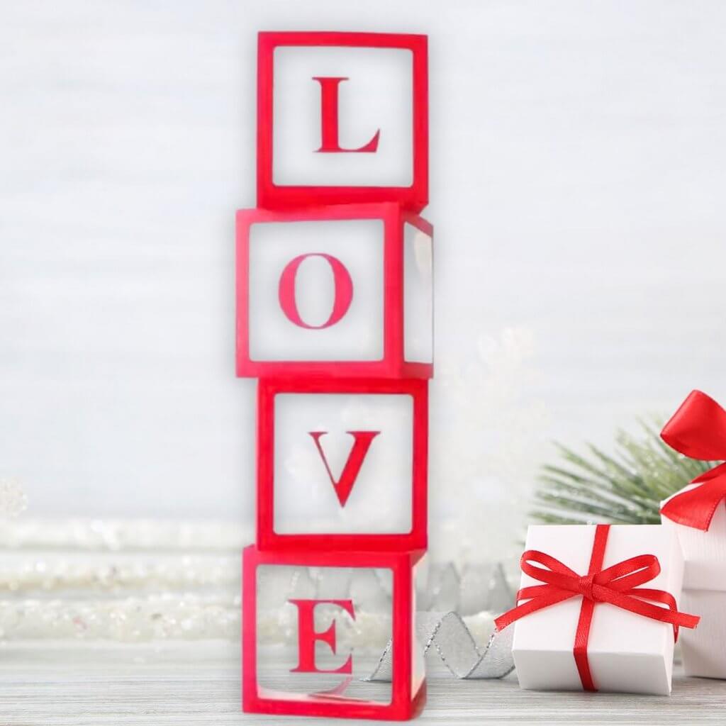 https://onlinepartysupplies.com.au/cdn/shop/files/clear-transparent-red-love-balloon-cube-boxes-blocks-wedding-bridal-shower-party-decorations-photo-backdrops_1600x.jpg?v=1699312093